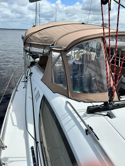 Yacht Photos Pics 2011 Jeanneau Sun Odyssey 45 DS sailboat with beige canopy on calm water.