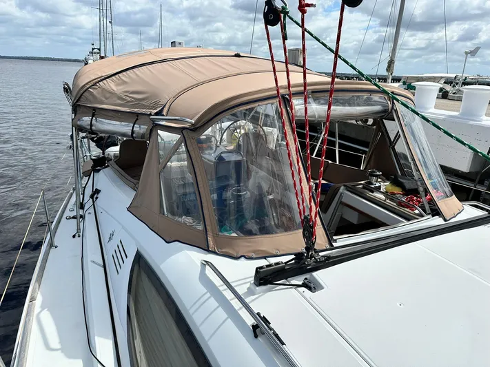  Yacht Photos Pics 2011 Jeanneau Sun Odyssey 45 DS sailboat with beige canopy docked by the water.