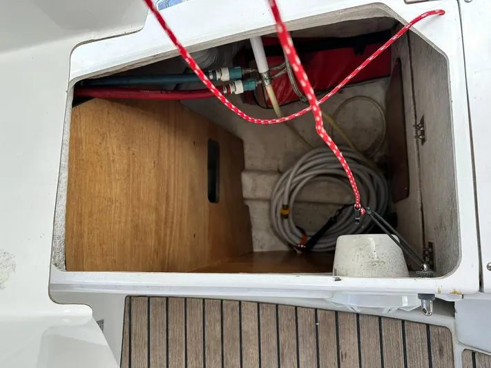  Yacht Photos Pics Storage compartment on 2011 Jeanneau Sun Odyssey 45 DS sailboat with ropes and hoses.