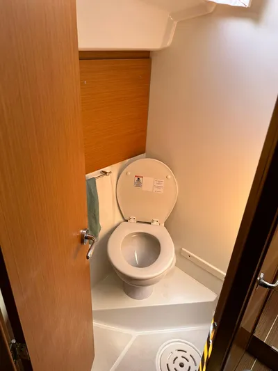  Yacht Photos Pics 2011 Jeanneau Sun Odyssey 45 DS yacht bathroom with toilet and wooden door.