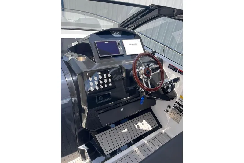  Yacht Photos Pics 2023 NX Boats 360 Sport Coupe helm with modern controls and wooden steering wheel.