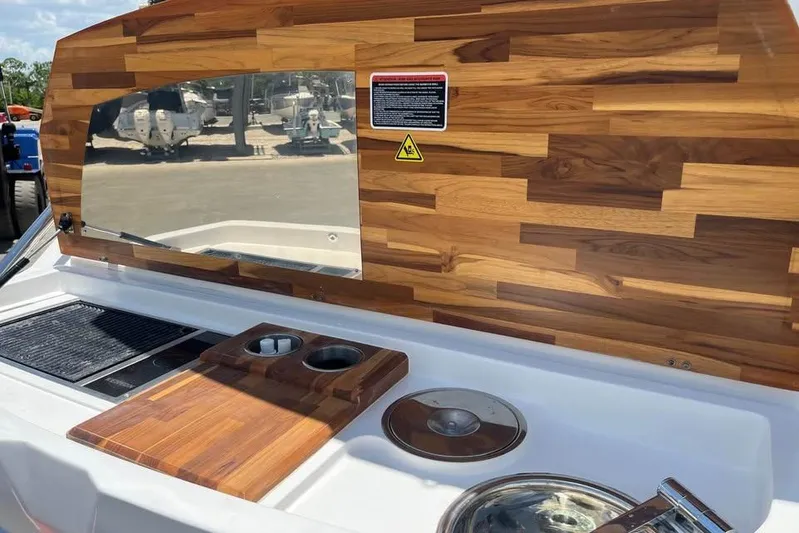  Yacht Photos Pics 2023 NX Boats 360 Sport Coupe kitchen area with wooden finish and modern amenities.