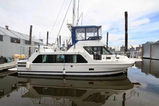 Smitten Yacht Photos Pics 2006 Harbor Master Coastal 400 yacht docked at marina, featuring sleek design and spacious cabin.