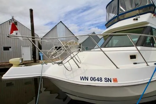 Smitten Yacht Photos Pics 2006 Harbor Master Coastal 400 boat docked near waterfront buildings.