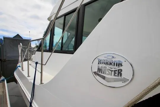 Smitten Yacht Photos Pics 2006 Harbor Master Coastal 400 yacht docked, showcasing sleek design and logo.