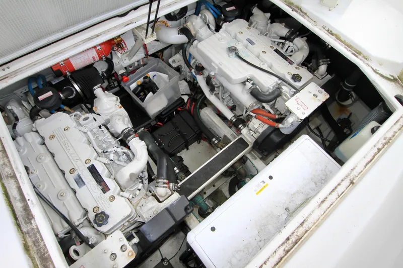 Smitten Yacht Photos Pics Engine compartment of a 2006 Harbor Master Coastal 400 boat, showcasing dual engines and components.