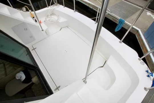 Smitten Yacht Photos Pics Deck view of 2006 Harbor Master Coastal 400 boat, featuring clean white surface and railing.