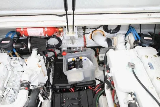 Smitten Yacht Photos Pics Engine compartment of a 2006 Harbor Master Coastal 400 with visible components and fire extinguisher.
