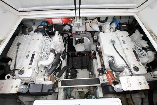 Smitten Yacht Photos Pics Engine room of 2006 Harbor Master Coastal 400 with dual engines and fire extinguisher.