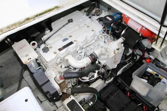 Smitten Yacht Photos Pics Engine compartment of a 2006 Harbor Master Coastal 400 boat, featuring a well-maintained engine.