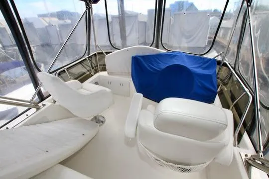 Smitten Yacht Photos Pics 2006 Harbor Master Coastal 400 boat interior with white seating and blue cover.