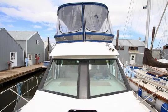 Smitten Yacht Photos Pics 2006 Harbor Master Coastal 400 boat docked at marina with nearby sailboats and buildings.