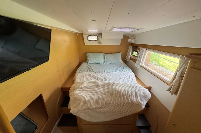 Willow Yacht Photos Pics Cozy bedroom interior of 2008 Lagoon 420 yacht with bed, windows, and TV.