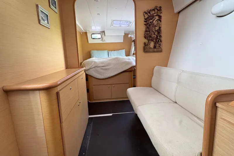 Willow Yacht Photos Pics Interior of 2008 Lagoon 420 yacht with cozy bed, sofa, and wooden decor.