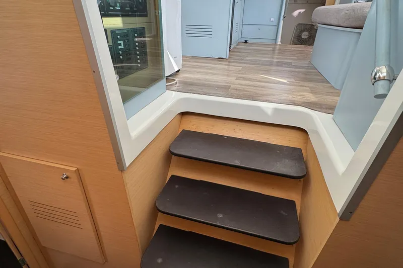 Willow Yacht Photos Pics Interior stairs of a 2008 Lagoon 420 yacht, featuring wooden steps and modern design.