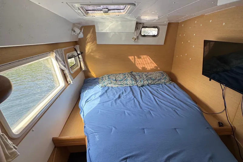 Willow Yacht Photos Pics Cozy bedroom in 2008 Lagoon 420 catamaran with blue bedding and scenic window views.