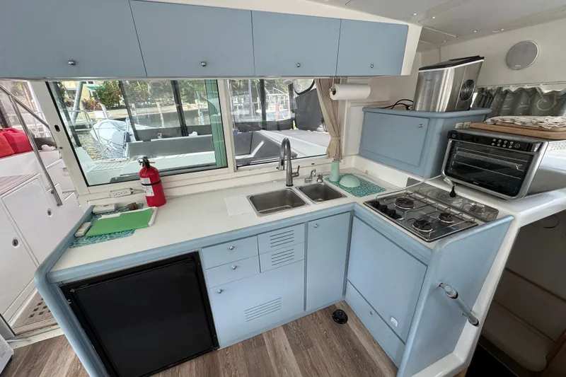 Willow Yacht Photos Pics Compact kitchen in a 2008 Lagoon 420 yacht with stove, sink, and oven.