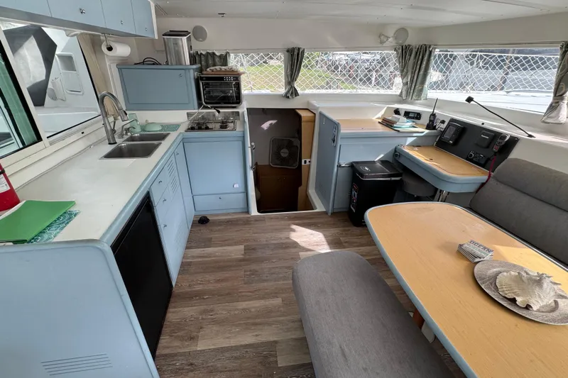 Willow Yacht Photos Pics Interior of 2008 Lagoon 420 catamaran with kitchen and dining area.