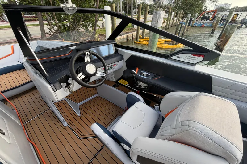 Coastal Edition Yacht Photos Pics 2022 Nautique Super Air Nautique G25 interior with modern dashboard and luxurious seating.