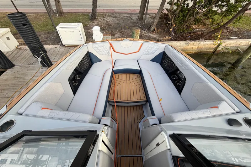 Coastal Edition Yacht Photos Pics 2022 Nautique Super Air Nautique G25 boat interior with luxurious seating and teak flooring.