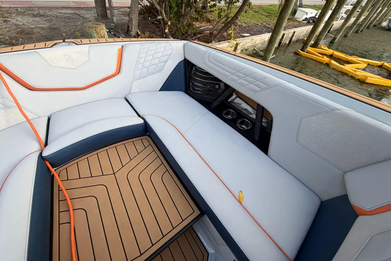 Coastal Edition Yacht Photos Pics 2022 Nautique Super Air Nautique G25 interior with stylish seating and teak flooring.