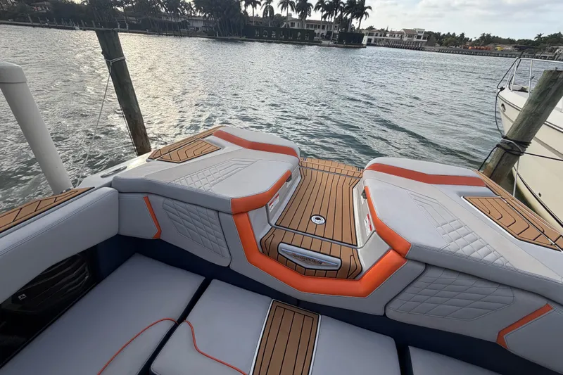 Coastal Edition Yacht Photos Pics 2022 Nautique Super Air Nautique G25 boat interior with stylish seating and wood accents.