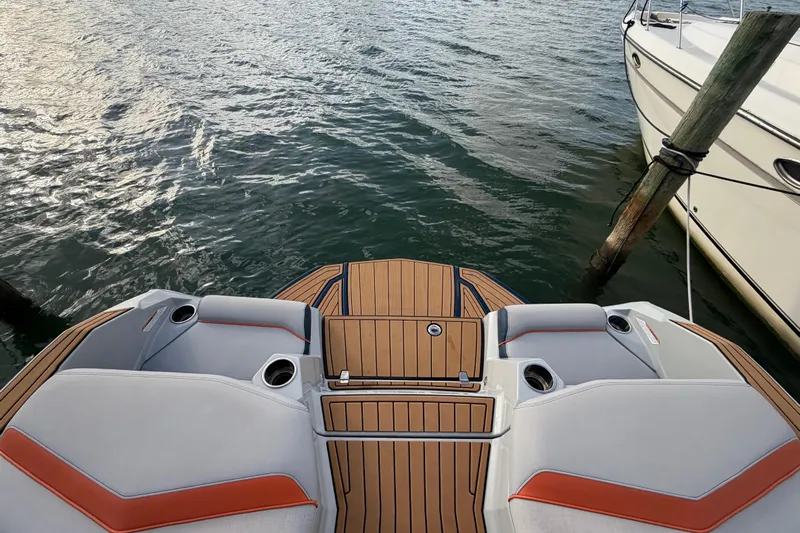 Coastal Edition Yacht Photos Pics 2022 Nautique Super Air Nautique G25 boat deck with cushioned seating and cup holders.