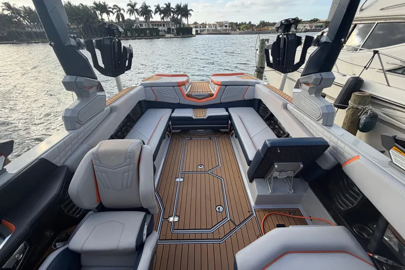 Coastal Edition Yacht Photos Pics 2022 Nautique Super Air Nautique G25 interior with luxurious seating and teak flooring.