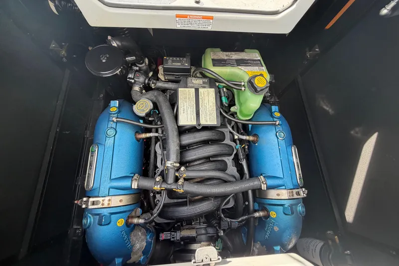Coastal Edition Yacht Photos Pics 2022 Nautique Super Air Nautique G25 engine compartment, showcasing powerful marine engine components.