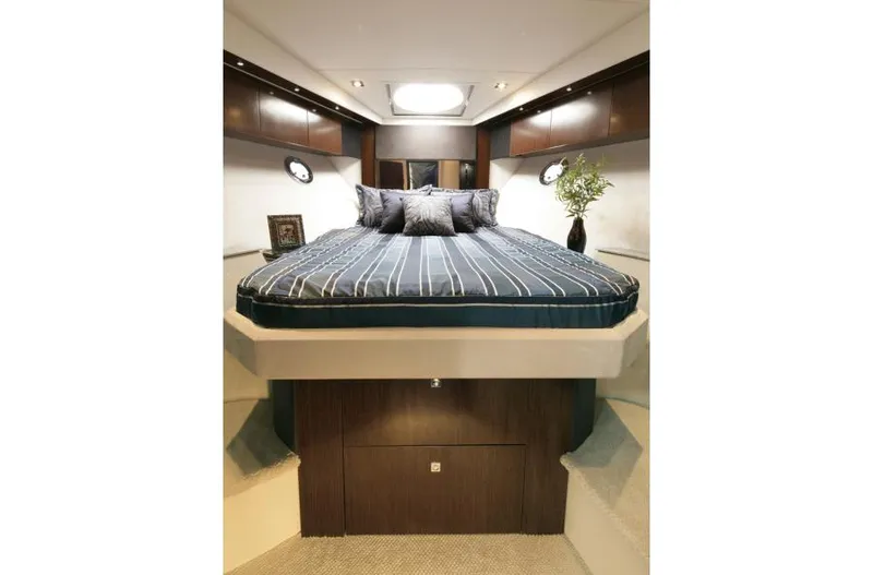 Osa Yacht Photos Pics Manufacturer Provided Image: Luxurious bedroom interior of 2012 Cruisers Yachts 41 Cantius with striped bedding.