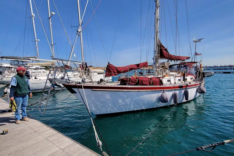 Talaria Yacht Photos Pics 1988 Tayana Vancouver 42 sailboat docked at marina, clear blue sky, calm water.
