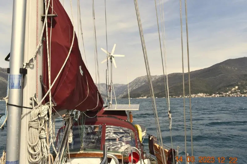 Talaria Yacht Photos Pics Sailing on a 1988 Tayana Vancouver 42 with mountains in the background.