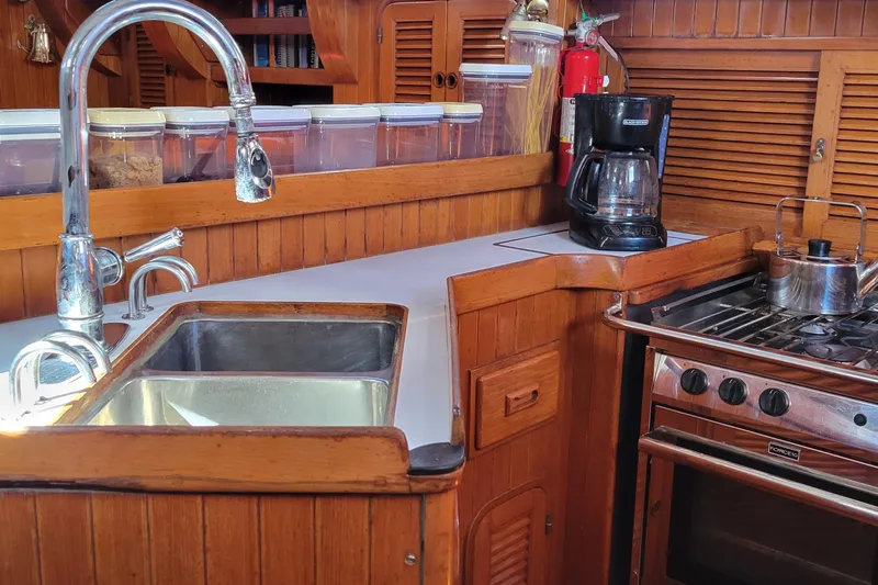 Talaria Yacht Photos Pics Galley kitchen in 1988 Tayana Vancouver 42 yacht with sink, stove, and coffee maker.