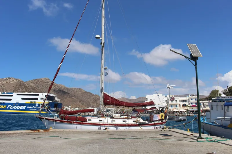 Talaria Yacht Photos Pics 1988 Tayana Vancouver 42 sailboat docked at a sunny marina with ferry in background.