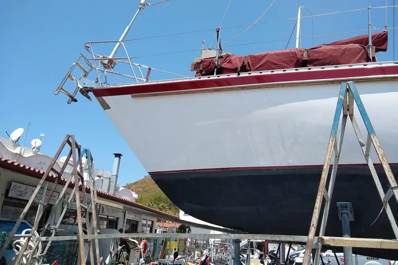 Talaria Yacht Photos Pics 1988 Tayana Vancouver 42 sailboat on dry dock, undergoing maintenance under clear blue sky.