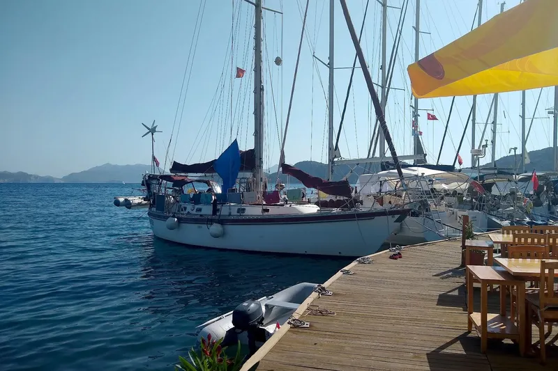 Talaria Yacht Photos Pics Sailboat Tayana Vancouver 42, 1988 model, docked at a sunny marina with wooden deck.