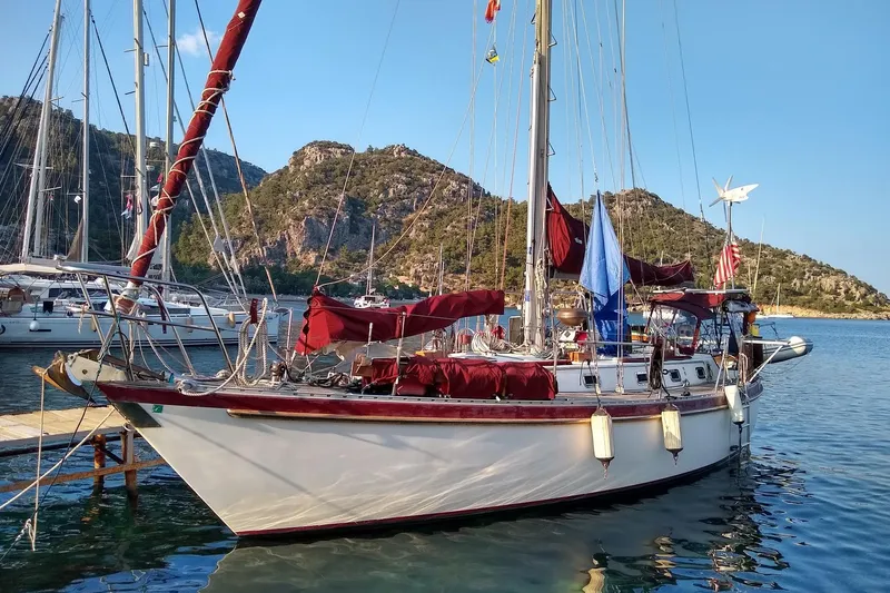 Talaria Yacht Photos Pics 1988 Tayana Vancouver 42 sailboat docked in scenic marina with mountainous backdrop.