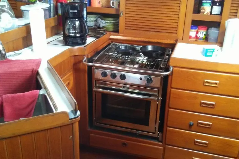 Talaria Yacht Photos Pics Galley kitchen in 1988 Tayana Vancouver 42 sailboat with stove and coffee maker.