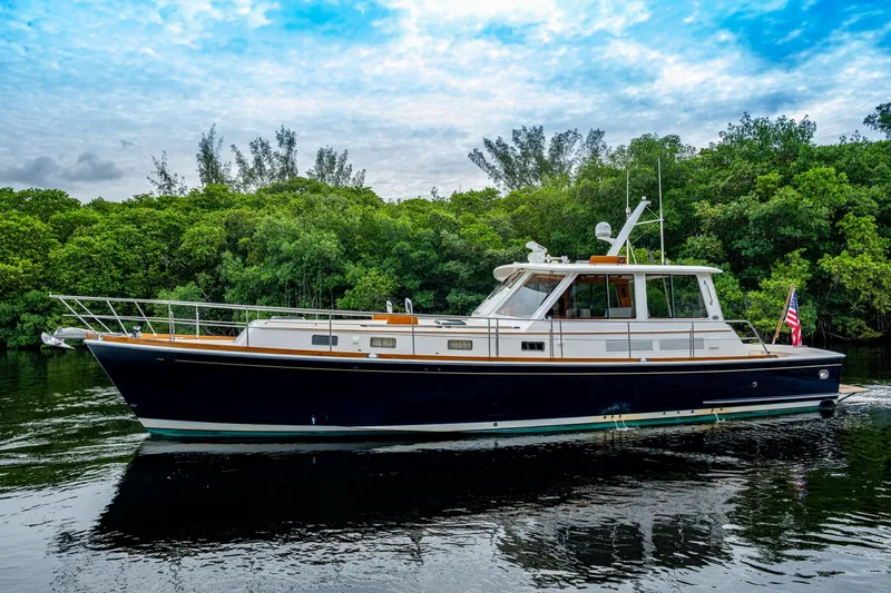 Bright Star Yacht Photos Pics 2003 Grand Banks 49 Eastbay HX yacht cruising on a serene waterway.