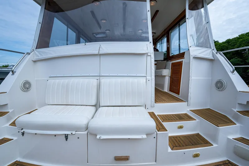 Bright Star Yacht Photos Pics 2003 Grand Banks 49 Eastbay HX yacht with white seating and teak steps.