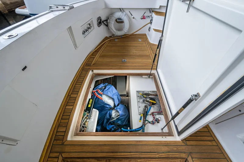 Bright Star Yacht Photos Pics Engine compartment of 2003 Grand Banks 49 Eastbay HX with wooden deck and storage area.