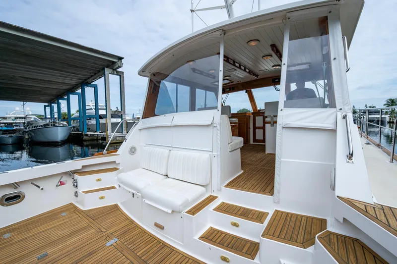 Bright Star Yacht Photos Pics 2003 Grand Banks 49 Eastbay HX yacht with teak deck and white seating at marina.