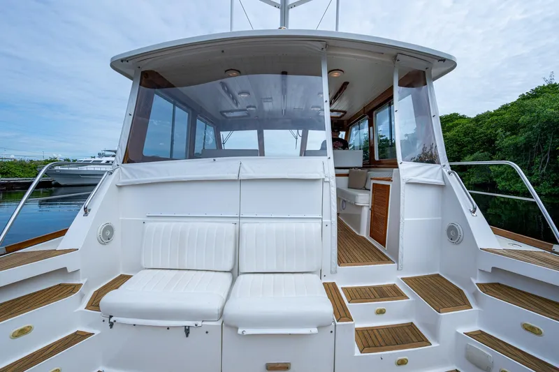 Bright Star Yacht Photos Pics 2003 Grand Banks 49 Eastbay HX yacht with white seating and wooden deck.