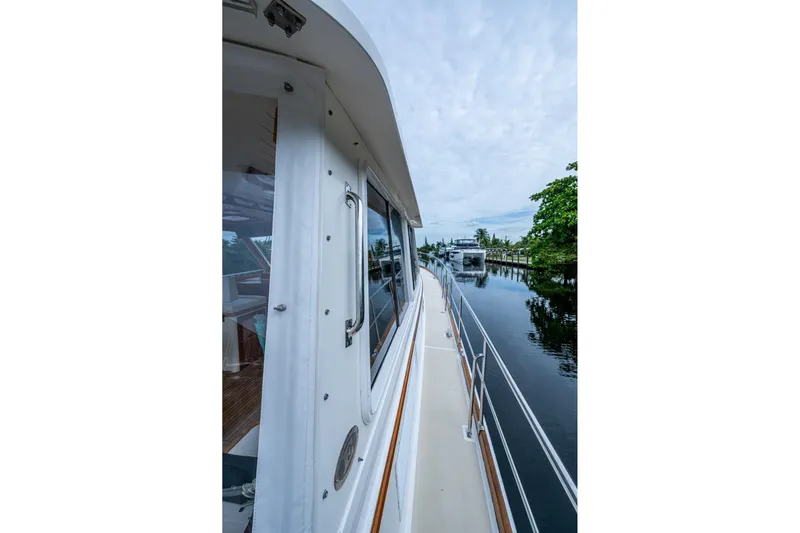 Bright Star Yacht Photos Pics Side view of 2003 Grand Banks 49 Eastbay HX yacht on calm waterway.