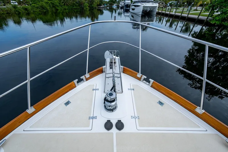 Bright Star Yacht Photos Pics Bow view of 2003 Grand Banks 49 Eastbay HX yacht on calm waterway.