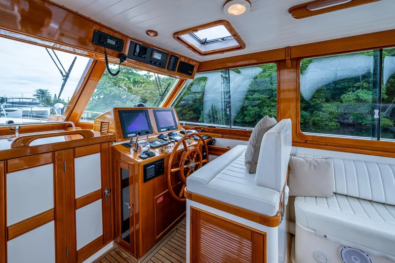 Bright Star Yacht Photos Pics Luxurious 2003 Grand Banks 49 Eastbay HX yacht interior with wooden helm and plush seating.
