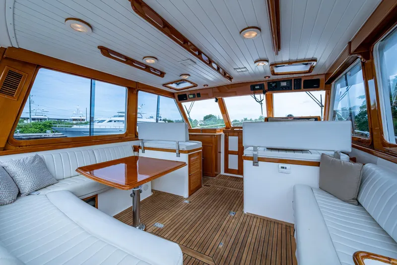 Bright Star Yacht Photos Pics Luxurious interior of 2003 Grand Banks 49 Eastbay HX yacht with elegant wood and white seating.