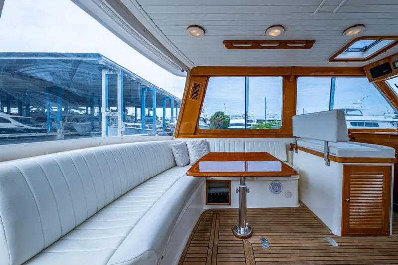 Bright Star Yacht Photos Pics Luxurious interior of 2003 Grand Banks 49 Eastbay HX yacht with elegant seating and wooden accents.