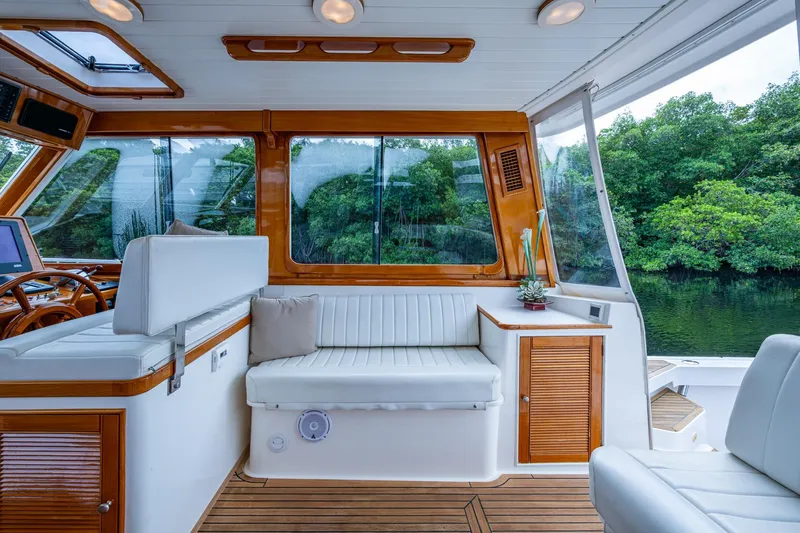 Bright Star Yacht Photos Pics Luxurious 2003 Grand Banks 49 Eastbay HX yacht interior with elegant seating and wood accents.