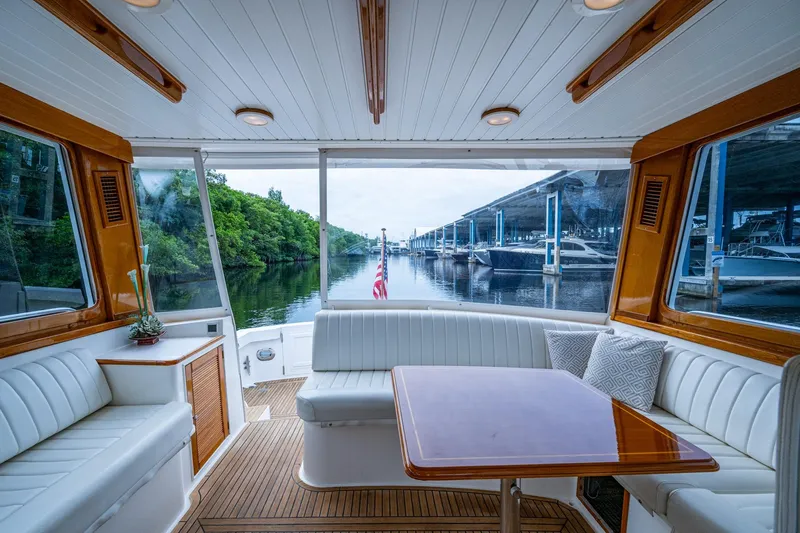 Bright Star Yacht Photos Pics Interior of 2003 Grand Banks 49 Eastbay HX yacht with elegant seating and table.